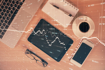 Multi exposure of forex graph hologram over desktop with phone. Top view. Mobile trade platform concept.