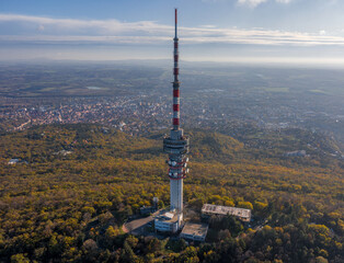 Fototapeta premium Hungary - TV tower in Pecs with Mecsek hills from drone view