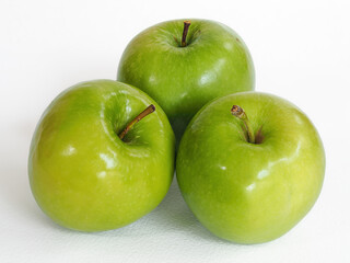 Photograph of three green apples