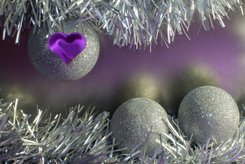 romantic winter greeting card with silver Christmas decorations, balloons, tinsel and purple heart...