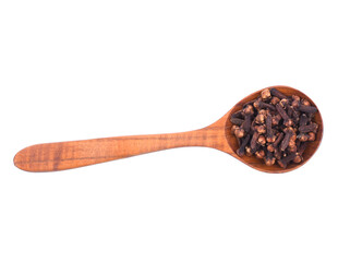 Dried cloves in a wooden spoon isolated on a white background top view