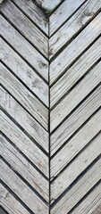 The old planks that were joined together made up the walkway patterned like the head of an arrow pointing downwards. Corner into a triangle
