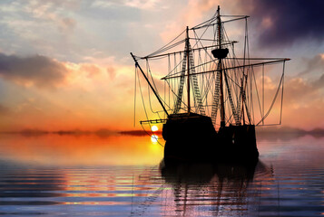 Pirate ship sailboat at the open sea during sunset