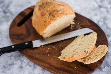 simple food ingredients, homemade australian damper bread without yeast freshly made and on top of cutting board