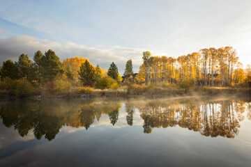 Reflections of fall color along the Deschutes river in Bend, Oregon