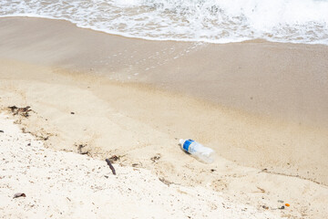 Empty Weathered Water Bottle On Sandy Beach, Tide Out. Sustainability, Pollution. Garbage. - stock photo