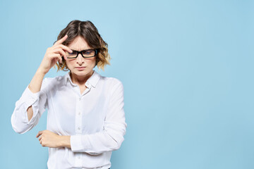 Business woman in a light shirt on a blue background gestures with her hands emotions model work