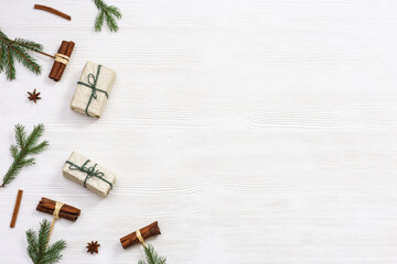 Handmade Christmas gifts decorated fir branches and cinnamon, winter holidays and New Year background