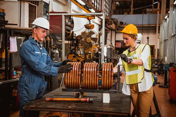 Industry engineer and worker  wearing safety uniform control operating Steel lathe grinding machine working in industry factory.