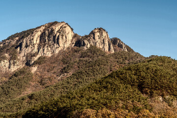 Mountain peak of granite against blue sky.