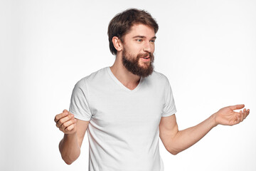 cheerful emotional bearded man gesturing with his hands close-up light background