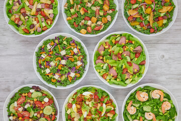 Colorful Fresh Wholesome Salads with Shrimp Edamame, Mediterranean Couscous, Roast Beef, Artichoke Ham, Grilled Chicken & Avocado and Cobb Salads.