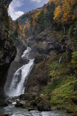 Fototapeta na wymiar Cascada Del Estrecho ( Estrecho waterfall) in Ordesa valley, in Autumn season, Heusca, Spain