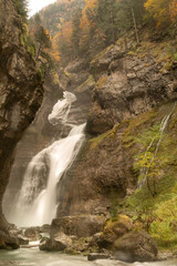 Fototapeta na wymiar Upright long exposure photography of runnning stream from Estrecho waterfall in Ordesa valley, in Autumn season, Heusca, Spain