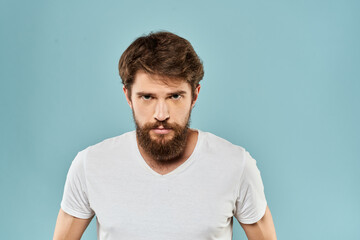 Obraz premium Man gestures with his hands emotions displeasure white t-shirt blue background