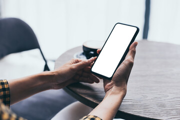 cell phone blank white screen mockup.woman hand holding texting using mobile on desk at office.background empty space for advertise.work people contact marketing business,technology