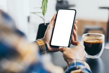 cell phone blank white screen mockup.woman hand holding texting using mobile on desk at office.background empty space for advertise.work people contact marketing business,technology