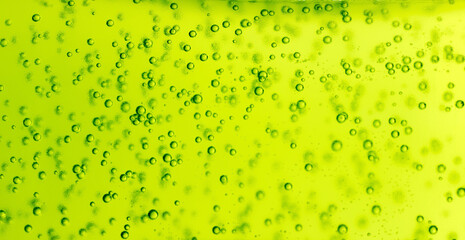 Green liquid with air bubbles inside. Texture with bubbles. Abstract texture and green color with...