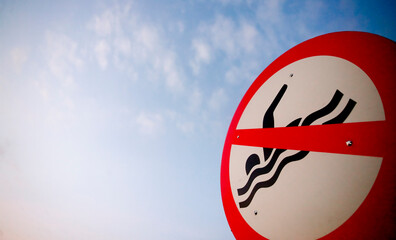 no swimming sign on the beach