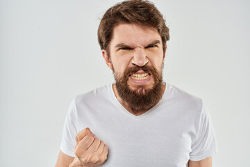 emotional man with a beard gesturing with his hands close-up studio aggression