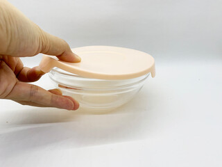 Glass food container with pastel cover isolated white background