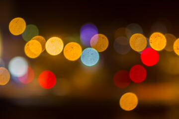 An beautiful Christmas background dark made of blurred colorful lights. Copy space