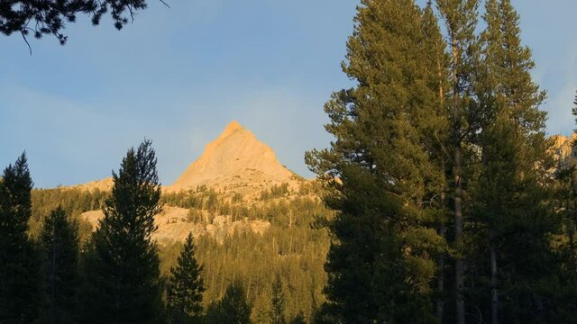 Sunset transition shot with trees in the foreground and an orange mountain in the background (60 fps slowed to 30 fps)
