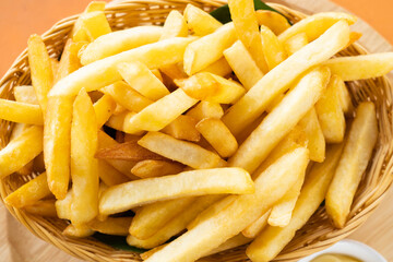 Tasty French fries or potato fry  with salt served in a wooden basket.Fastfood.