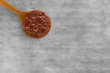 A spoon with Brazilian Feijoada Food. Top view. wooden table background. Copy sapce