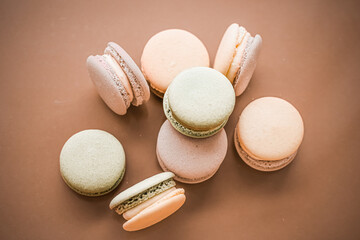 Pastry, bakery and branding concept - French macaroons on cream beige background, parisian chic...