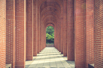 A red brick arcade. Toned image.