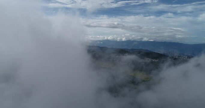 Aerial view of farmland and cloudscape of Yuanyang Terrace Scenic Area