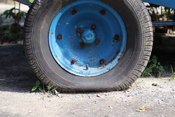 Fototapeta na wymiar Flat tire wheel of a car on the floor cement outdoor,portrait.