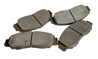 Old car front brake pads on white background