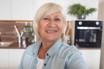 Selfie portrait of smiling 60 year old woman