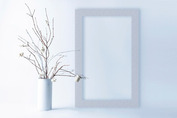 Template with photo frame on white background. Bouquet of Snowberry with white branches in a vase. Mock up in high key.