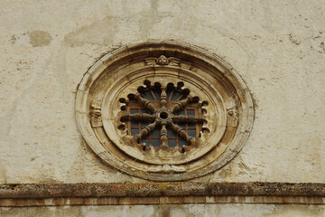 Fototapeta na wymiar The ancient and characteristic rose window of the Parish Church of Santa Maria della Valle also called dell'Assunta, is the main church of Scanno, in the province of L'Aquila.