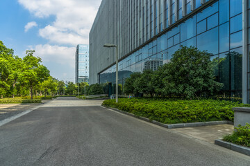 clean asphalt road through office block area, suzhou, china