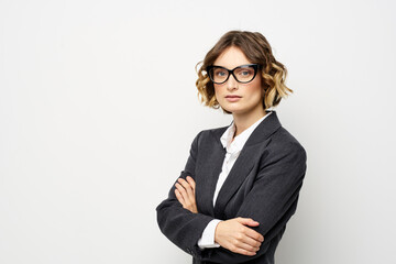 confident business woman in suit gesturing with hands work light background