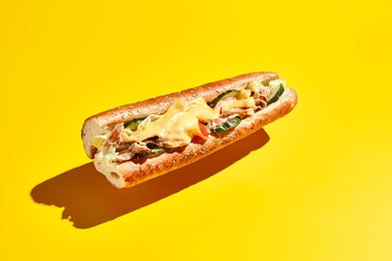 Flying chicken sandwich on yellow background