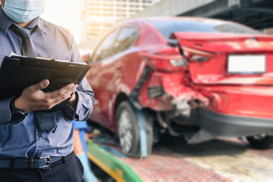 Asian saleman inspector checking writing on clipboard change wheels in garage of dealership mechanic In showroom car and insurance for check to travel to happy new year 2021