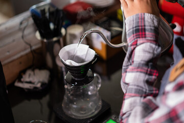 closeup barista pour water into a cup in a cafe