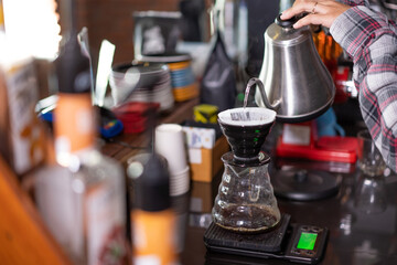 barista make a coffee for a customer in a cafe