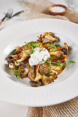 Fried potato with mushrooms and sour cream