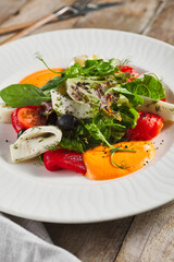 Roasted pepper salad with calamari and fresh greens