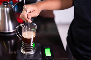 barista make a coffee for a customer in a cafe