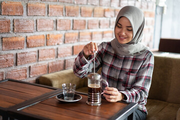 asian female smiling at cafe and enjoyed a coffee alone