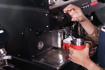 make a coffee with coffee machine in cafe