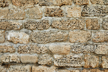 Background of the stone wall of the castle made of stones of different shapes and sizes and textures