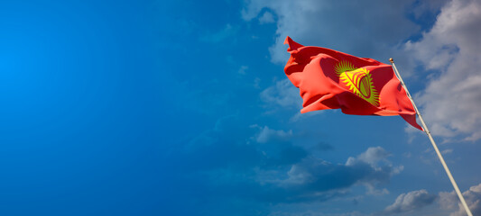 Kyrgyzstan national flag with blank text space on wide background.